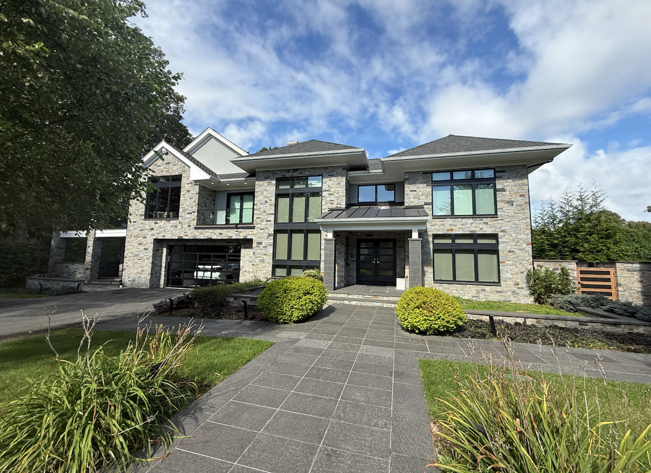 Contemporary home facade with natural thin stone veneer and modern architecture